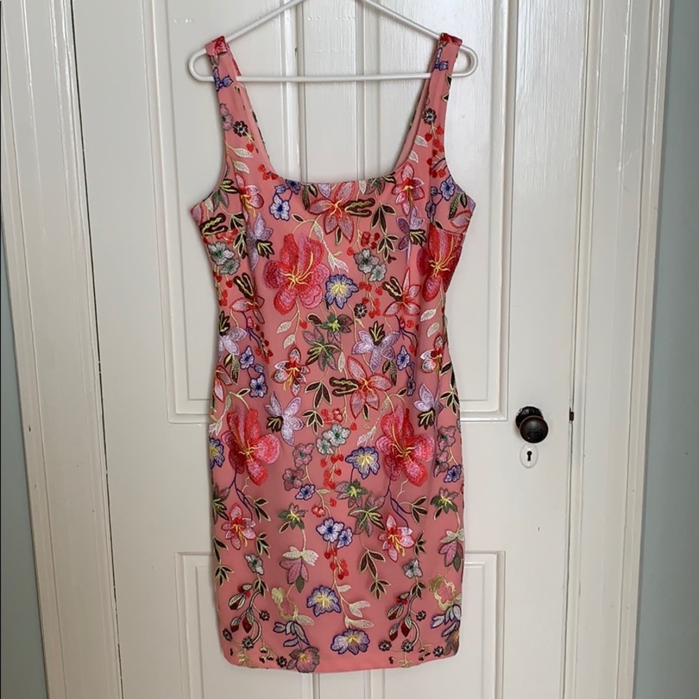 Sewn in floral pattern over a pink slip.